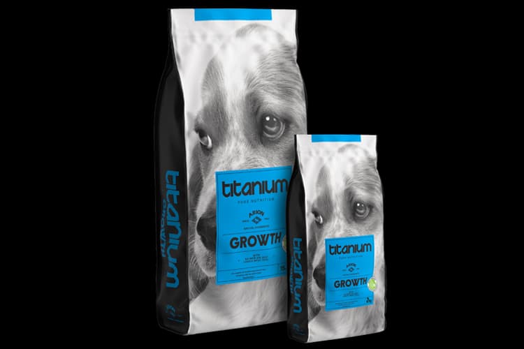 Titanium Growth dog food bags with a black and white puppy face and blue labels.